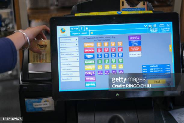 Cashier prints out a Mega Millions lottery ticket at a 7-Eleven convenience store in Chino Hills, California, July 28, 2022. The odds of claiming...