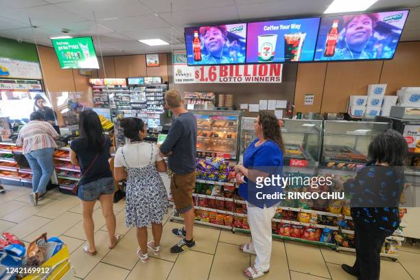 People wait in line to buy their Mega Millions lottery tickets at a 7-Eleven convenience store in Chino Hills, California, July 28, 2022. The odds of...