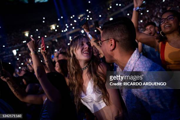 Fans dance as they watch Puerto Rican rapper Bad Bunny perform on stage as part of his three-day "Un Verano Sin Ti" concert at the Coliseo de Puerto...
