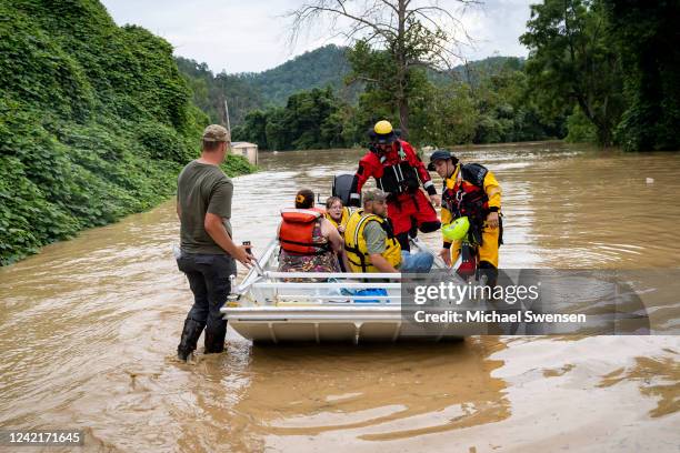 Rescue team from the Jackson Fire Department assists people out of floodwaters downtown on July 28, 2022 in Jackson, Kentucky. Storms that dropped as...