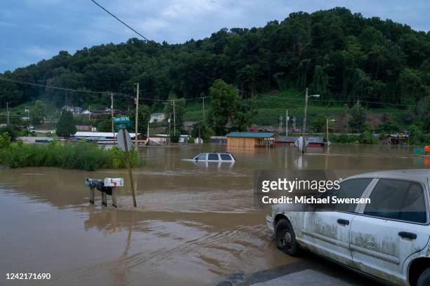 Vehicles are seen in floodwaters downtown on July 28, 2022 in Jackson, Kentucky. Storms that dropped as much as 12 inches of rain in some parts of...