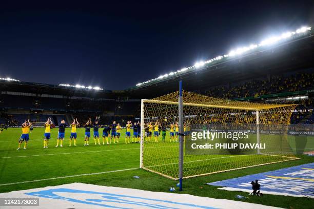 Brondby IF's players greet their supporters after winning at the end of the Europa Conference League qualifying football match between Brondby IF and...