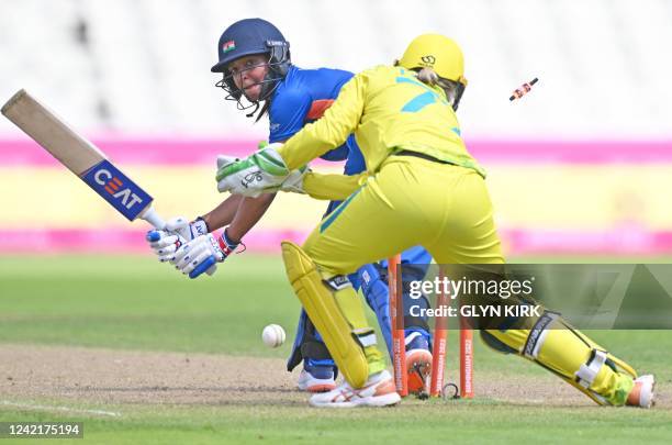 India's Harmanpreet Kaur is bowled out by Australia's Meghan Schutt during the women's Twenty20 cricket match between Australia and India on day one...