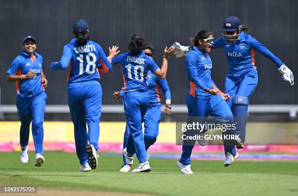 India celebrate the dismissal of Australia's Alyssa Healy during the women's Twenty20 cricket match between Australia and India on day one of the...