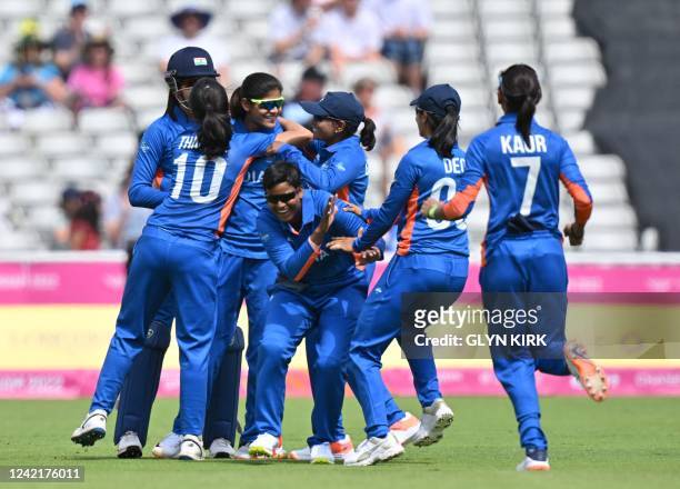 India players celebrate India's Renuka Singh Thakur's dismissal of Australia's Meg Lanning during the women's Twenty20 cricket match between...