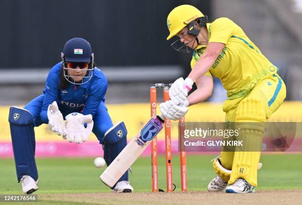 Australia's Grace Harris hits a four during the women's Twenty20 cricket match between Australia and India on day one of the Commonwealth Games at...