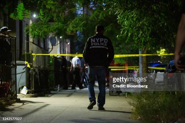 New York Police Department officers investigate the scene of a shooting in the Crown Heights neighborhood in the Brooklyn borough of New York, U.S.,...