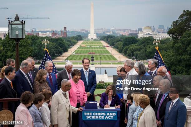 Speaker of the House Nancy Pelosi , alongside House Democrats, signs the CHIPS For America Act during a bill enrollment ceremony outside the U.S....