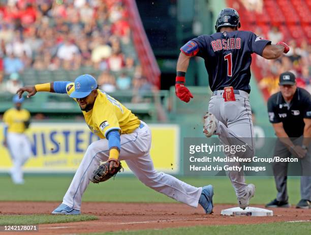 Franchy Cordero of the Boston Red Sox steps off the bag as Amed Rosario of the Cleveland Guardians makes it to first base during the first inning of...