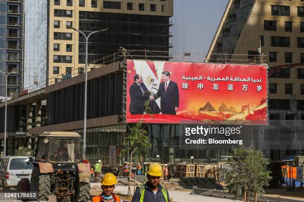 Hoarding displaying an image of Abdel-Fattah El-Sisi, Egypt's president, and Xi Jinping, China's president, on an under-construction building in the...