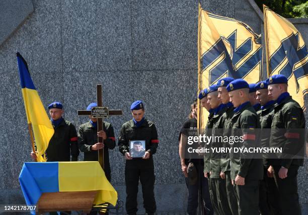 Ukrainian soldiers attend the funeral ceremony of Vasyl Sushchuk, an Azov regiment serviceman killed during the Russian invasion of Ukraine, at the...