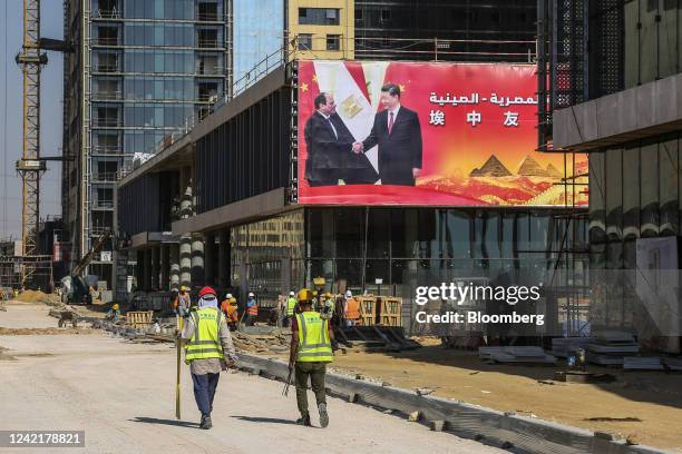 Hoarding displaying an image of Abdel-Fattah El-Sisi, Egypt's president, and Xi Jinping, China's president, on an under-construction building in the...