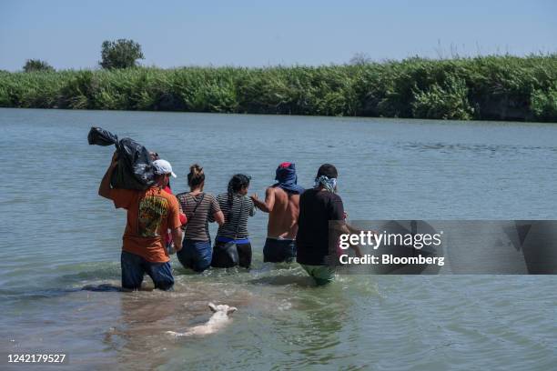 Migrants assisted by smugglers cross the Rio Grande into the US in Piedras Negras, Coahuila state, Mexico, on Thursday, July 28, 2022. Washington,...