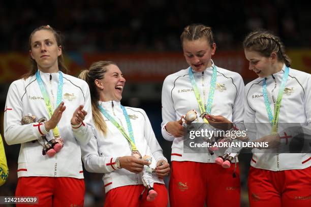 England's Laura Kenny and teammates celebrate with their bronze medals on the podium during the medal presentation ceremony for the women's 4000m...