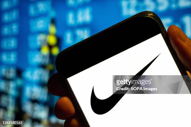 In this photo illustration, the American multinational sport clothing brand Nike's logo is displayed on a smartphone screen.