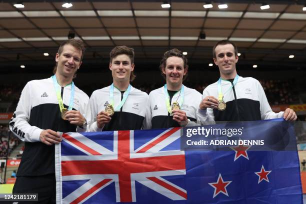 Gold medallists of team New Zealand pose after their medal presentation ceremony for the men's 4000m team pursuit on day one of the Commonwealth...