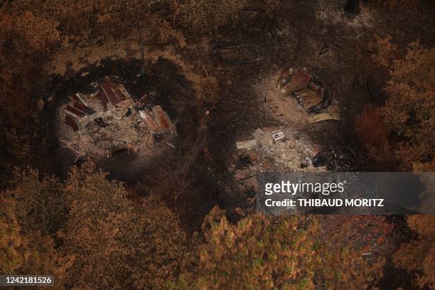This aerial view taken on July 29, 2022 shows destroyed resin workers shelters amid damaged forest after wildfires near La Teste-de-Buch,...