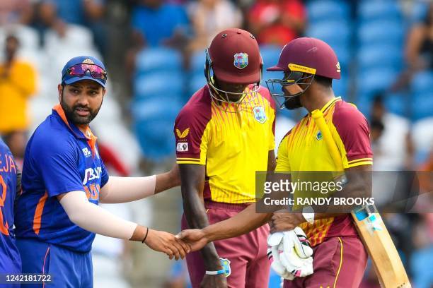 Rohit Sharma of India is congratulated by Keemo Paul of West Indies after winning the 1st T20i match between West Indies and India at Brian Lara...