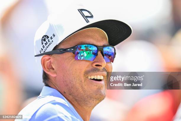 Rickie Fowler laughs while standing on the first tee box during the second round of the Rocket Mortgage Classic at Detroit Golf Club on July 29, 2022...