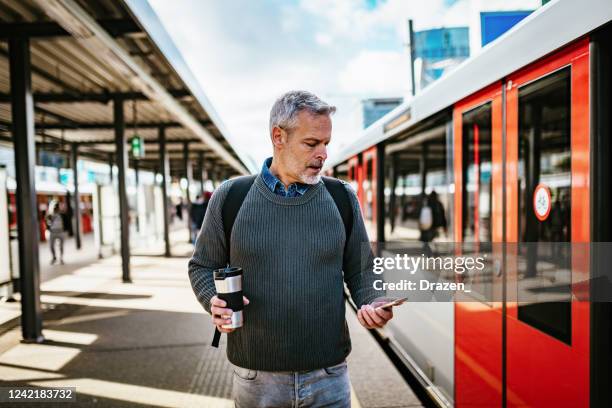 mature gray hair man commuting - man backpack stock pictures, royalty-free photos & images