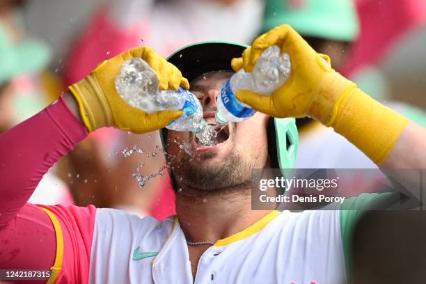 Luke Voit of the San Diego Padres celebrates in the dugout after hitting a two-run home run during the first inning of a baseball game against the...