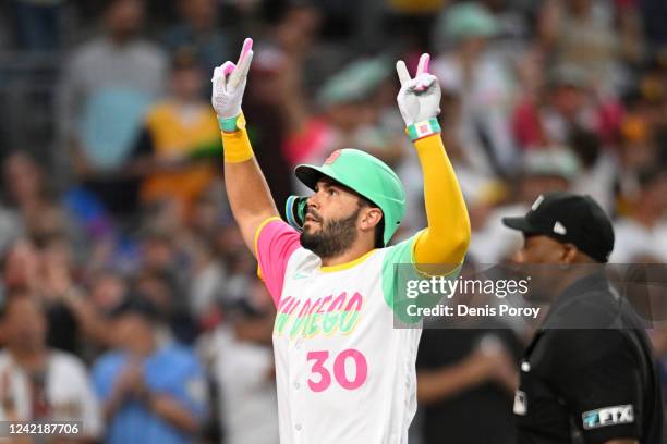 Eric Hosmer of the San Diego Padres celebrates after hitting a solo home run during the fourth inning of a baseball game against the Minnesota Twins...