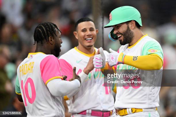 Eric Hosmer of the San Diego Padres is congratulated by Manny Machado and Jurickson Profar after hitting a solo home run during the fourth inning of...