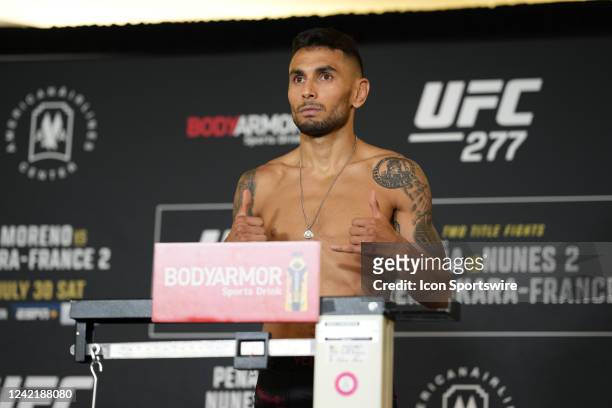 Alex Perez steps on the scale for the official fight weigh-in for UFC 277 on July 29 at the Hyatt Regency Dallas in Dallas, TX.