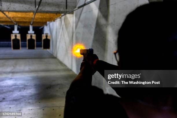 Monique Chapman shoots at a target during a live fire test to get a conceal carry permit at Maryland Small Arms Range in Upper Marlboro, MD on July...