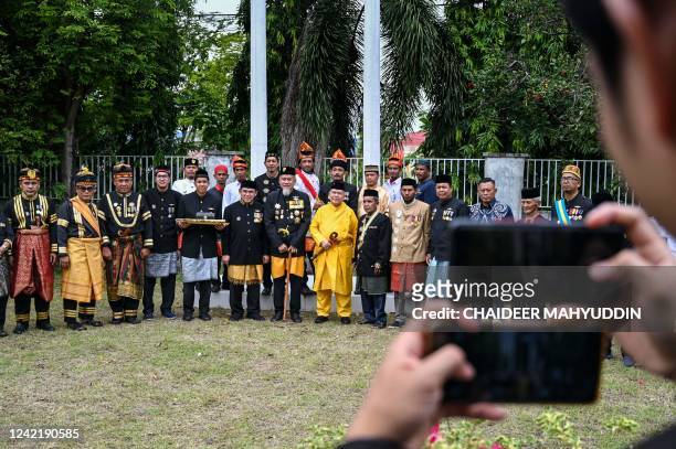 The descendants of the Aceh kingdom poses for photographs after taking part in a cultural ceremony to raise the royal flag to celebrate the Islamic...