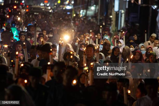 Muslim hold torches and sing an Islamic song as they parade to welcome the Islamic New Year in Jakarta on 29 July 2022. Thousands of Indonesian...
