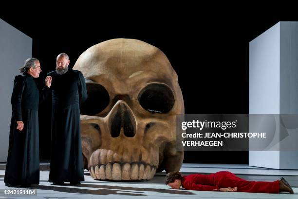 Belgium's actor Hugues Dutrannois and French actor Sylvain Grepinet and French actress Georgia Scalliet perform on stage the play « Hamlet », written...