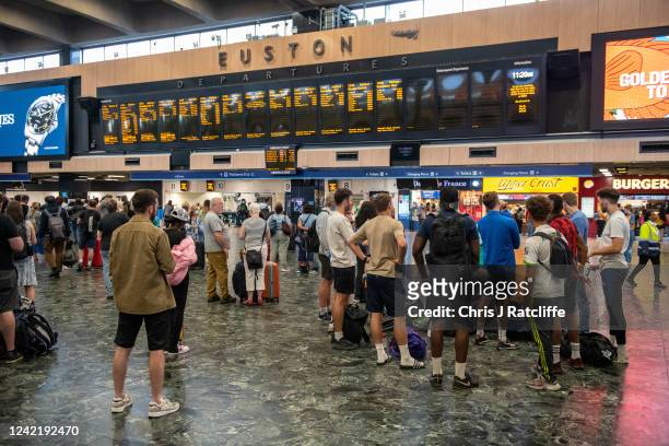 Rail passengers wait for announcements at Euston train station on July 30, 2022 in London, United Kingdom. ASLEF Union says that train drivers have...