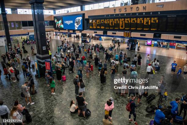 Rail passengers wait for announcements at Euston train station on July 30, 2022 in London, United Kingdom. ASLEF Union says that train drivers have...