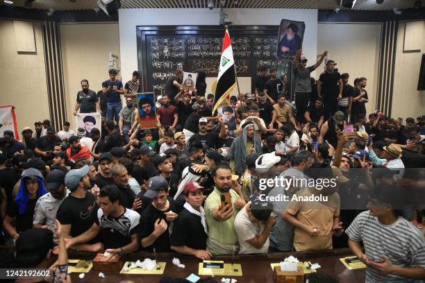 Supporters of Shiite cleric Moqtada al-Sadr storm the Iraqi parliament building in Baghdad's fortified Green Zone for the second time in a week as...