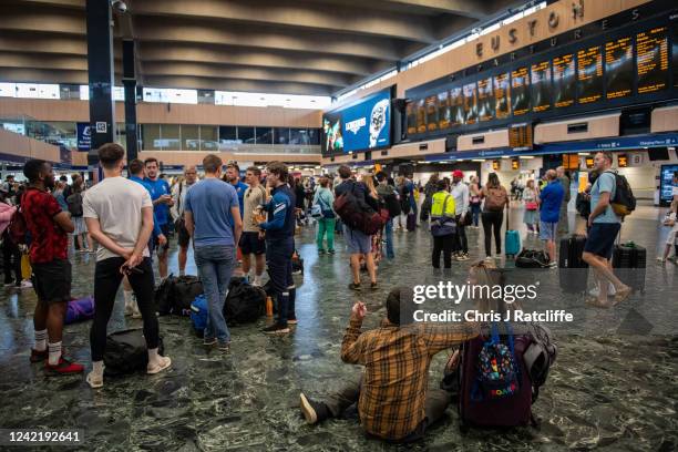 Rail passengers wait for announcements at Euston train station on July 30, 2022 in London, United Kingdom. ASLEF Union says that train drivers have...