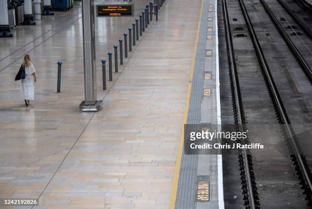 Rail passenger walks along an empty train platform at Paddington station during industrial strike action by ASLEF on July 30, 2022 in London, United...