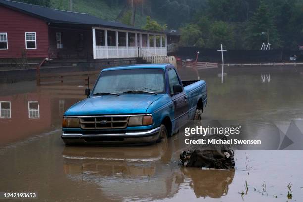 Receded water levels from the North Fork of the Kentucky River surround a truck in downtown Jackson on July 30, 2022 in Jackson, Kentucky. At least...