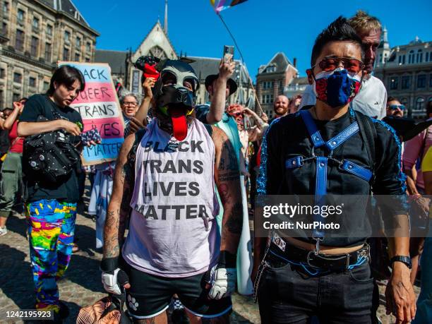 Man is wearing a pro trans black lives matter while wearing a leather dog mask, during the celebration of the Pride walk in Amsterdam, on July 30th,...