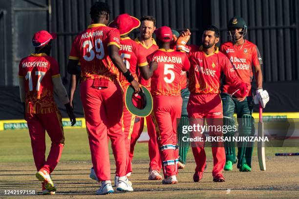 Zimbabwe player Sikandar Raza congratulates his team mates in celebrating victory during the first T20 cricket match played between Bangladesh and...