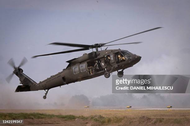 Military personnel of the US Army's 101st Airborne Division take off with a Black Hawk helicopter during a demonstration drill at Mihail Kogalniceanu...