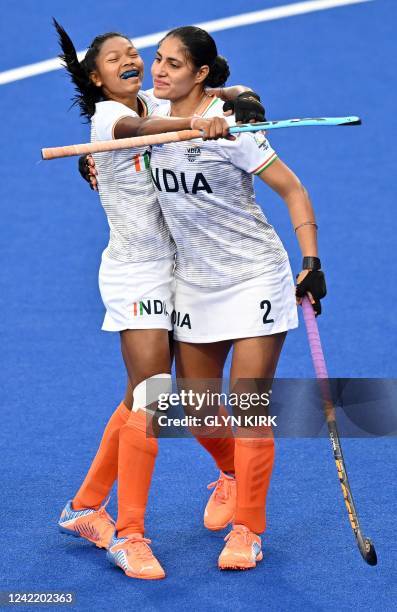 India's Kaur Gurjit celebrates with Salima Tete after the first goal during the women's hockey match between India and Wales on day two of the...