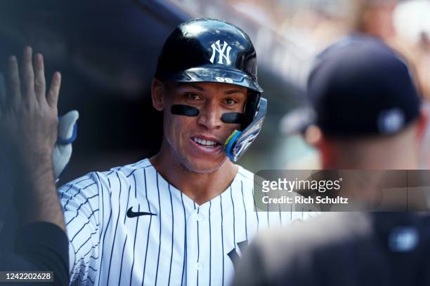Aaron Judge of the New York Yankees is congratulated after he hit a two-run home run against the Kansas City Royals during the third inning of a game...