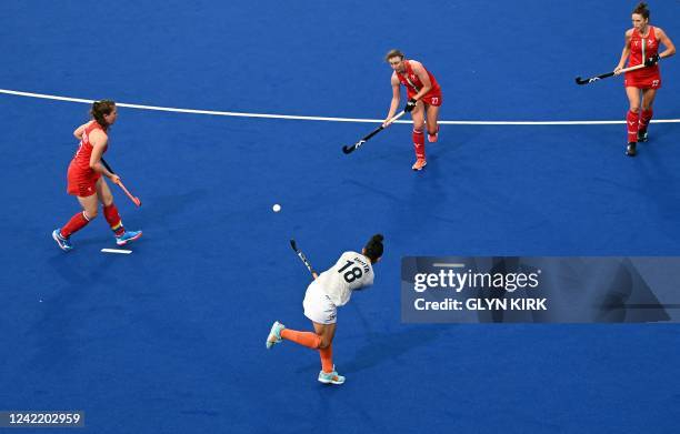 Indias Udita crosses the ball during the women's hockey match between India and Wales on day two of the Commonwealth Games at the University of...