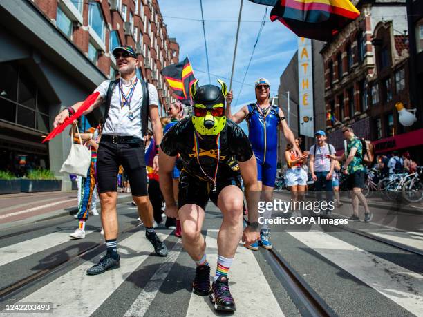 Man wearing a leather dog mask is seen walking towards the camera. The annual equal rights demonstration for the global rainbow community took place...