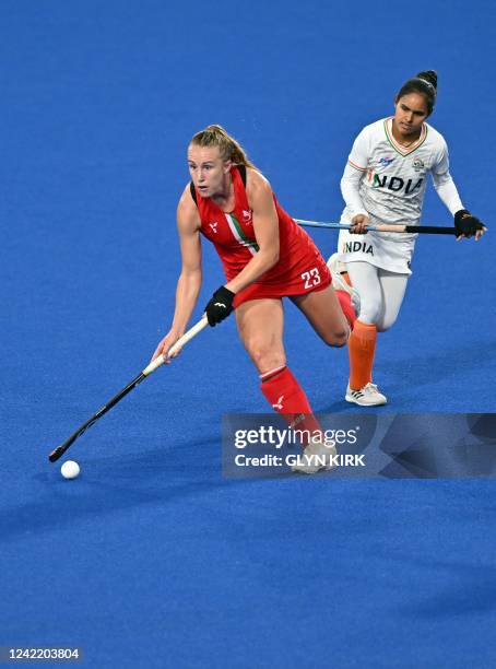 Wales Hannah Cozens runs with the ball during the women's hockey match between India and Wales on day two of the Commonwealth Games at the University...