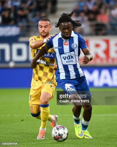 S Fatih Kaya and Gent's Jordan Torunarigha fight for the ball during a soccer match between KAA Gent and Sint-Truidense VV, Saturday 30 July 2022 in...