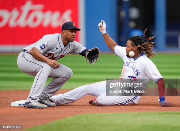 Vladimir Guerrero Jr. #27 of the Toronto Blue Jays steals second base against Jonathan Schoop of the Detroit Tigers in the first inning during their...