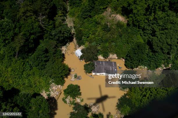 In this aerial view, floodwater surrounds a house as the Kentucky National Guard fly a recon and rescue mission on July 30, 2022 in Breathitt County...