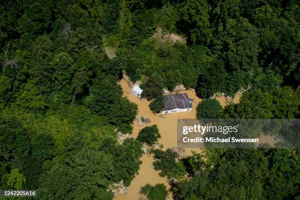 In this aerial view, floodwater surrounds a house as the Kentucky National Guard fly a recon and rescue mission on July 30, 2022 in Breathitt County...